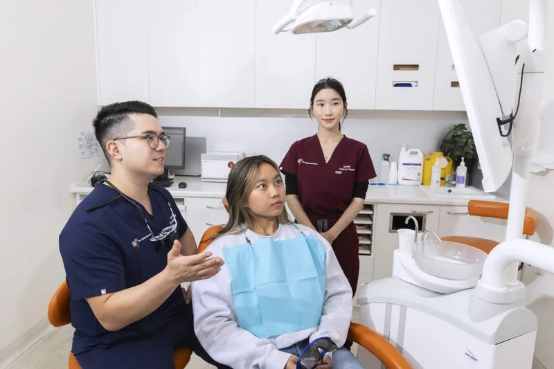 Melbourne Implant Dentist clinicians reviewing a treatment plan with a patient