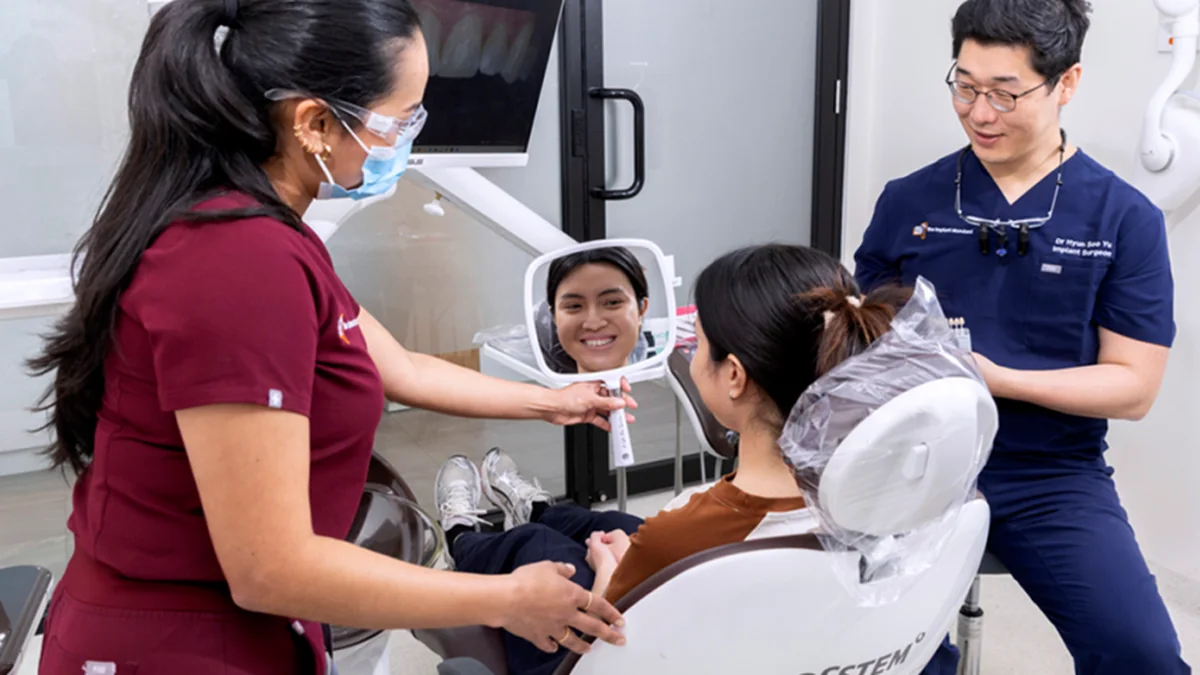 Melbourne Implant Dentist team chairside with a patient